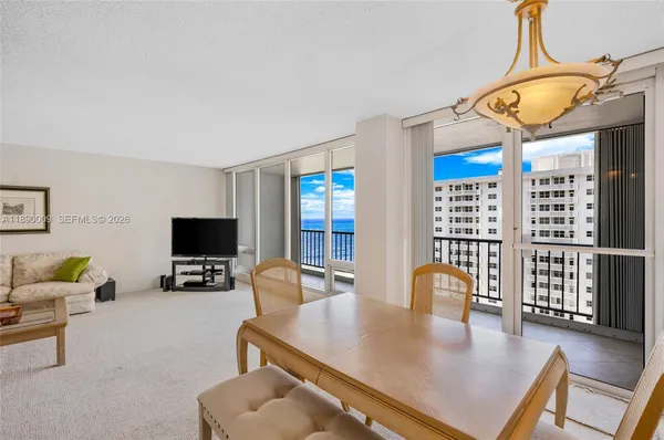 a living room with furniture a flat screen tv and a large window