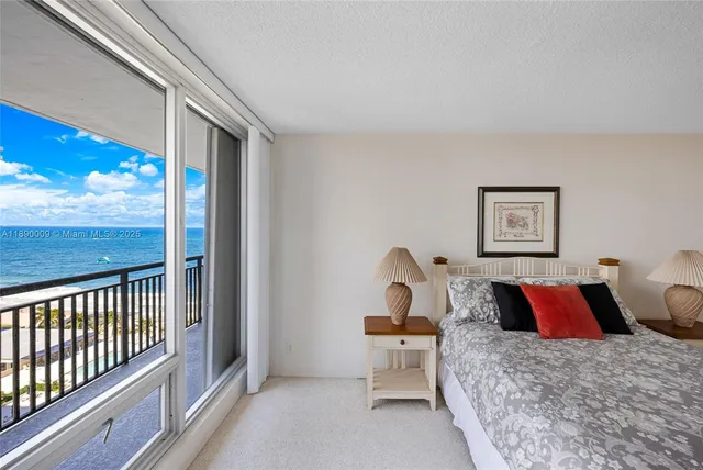 a bedroom with a bed and a flat tv screen on dresser
