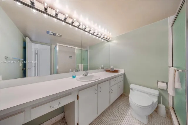 a spacious bathroom with a double vanity sink mirror and toilet