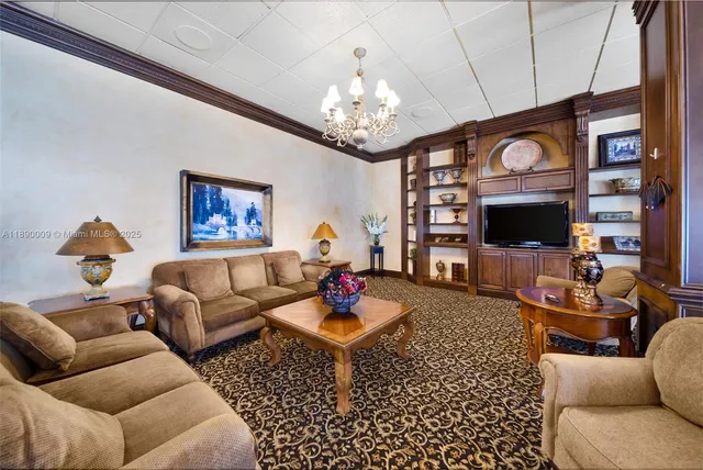 a living room with furniture a flat screen tv and a chandelier