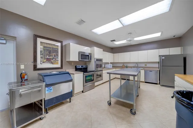 a living room with furniture and a kitchen view