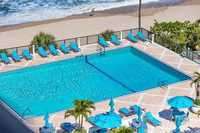 a view of a swimming pool with an outdoor seating