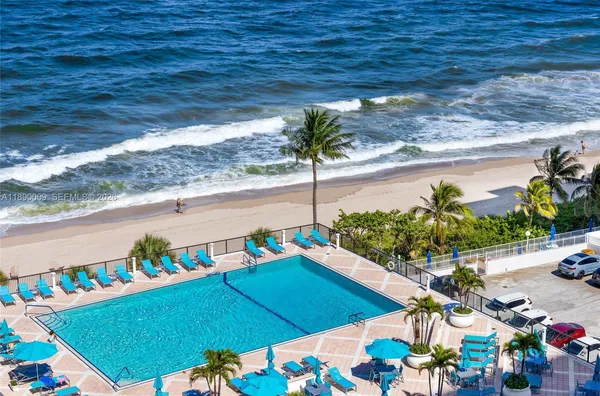 a view of a swimming pool with an outdoor seating