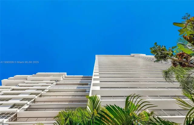 a view of a yard with a wooden fence