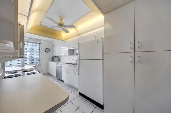 a kitchen with appliances cabinets a sink and a stove top oven