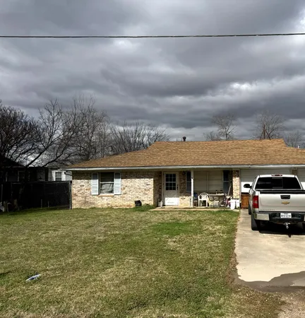 a view of a car park in front of house