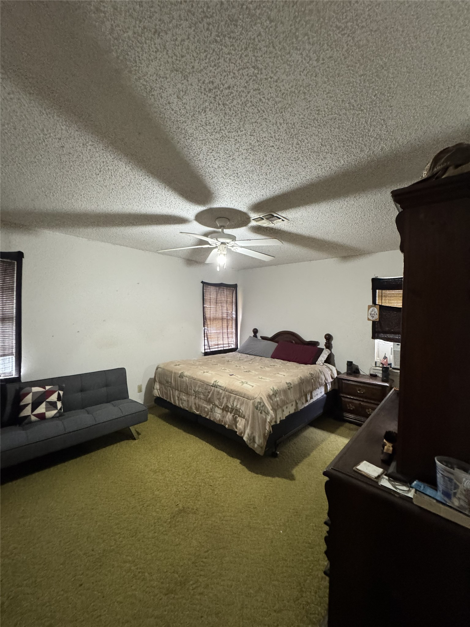 106 North 7th Street Dawson, TX 76639 - Photo 14 of 28 Carpeted bedroom with a textured ceiling and ceiling fan