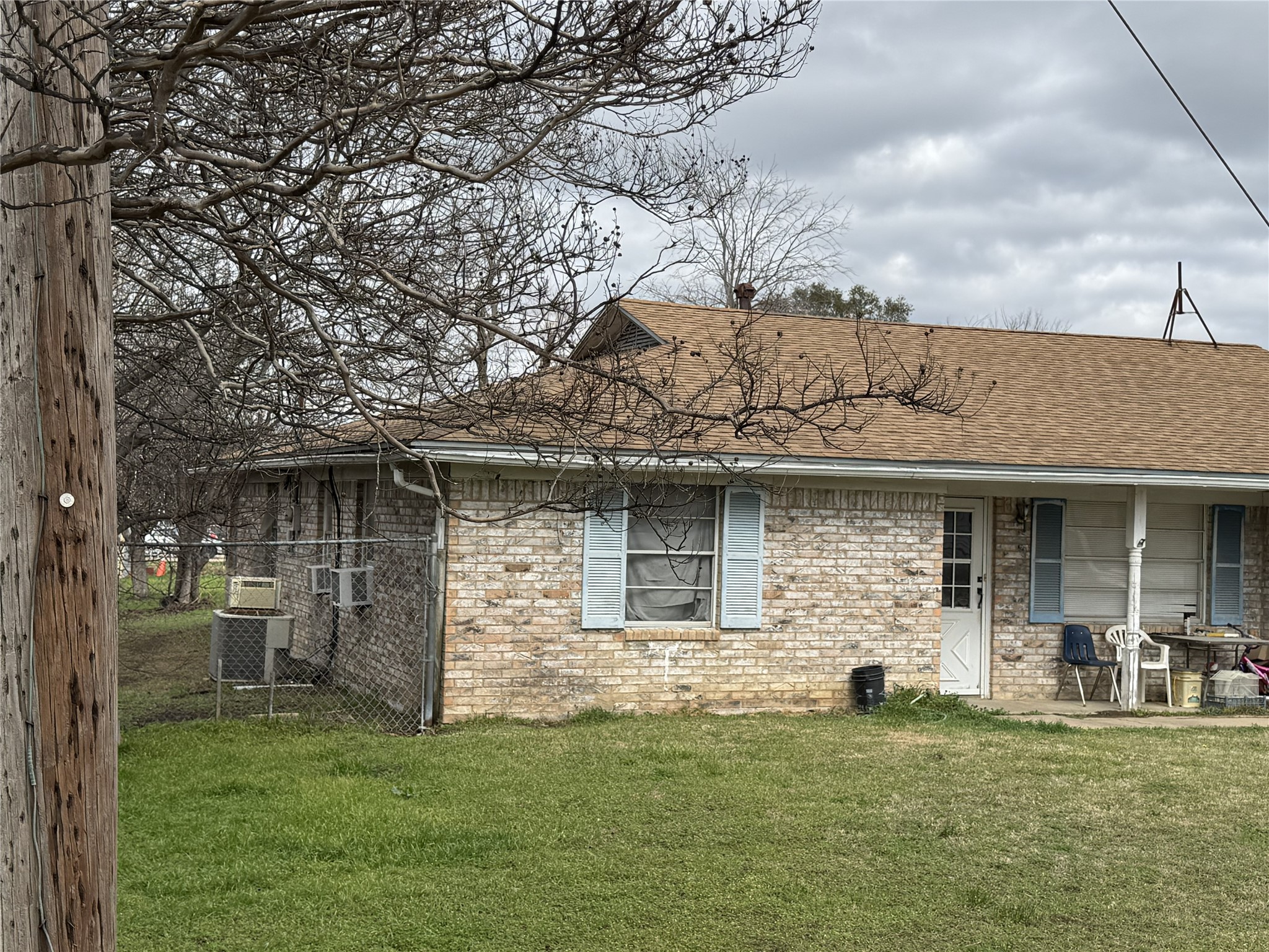 106 North 7th Street Dawson, TX 76639 - Photo 2 of 28 Back of house featuring a shingled roof, a patio, and brick siding