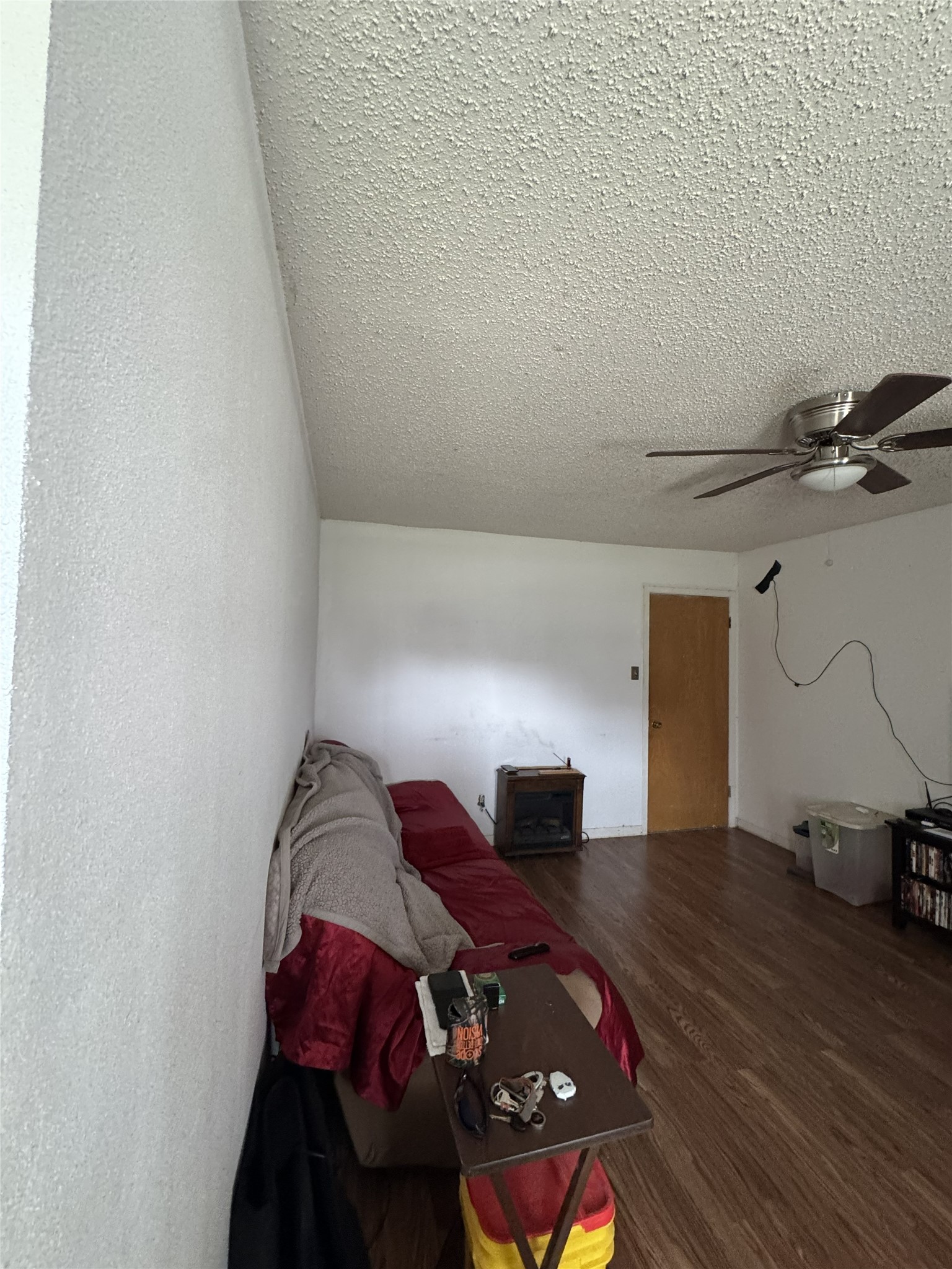 106 North 7th Street Dawson, TX 76639 - Photo 6 of 28 Living area featuring ceiling fan, wood finished floors, and a textured ceiling