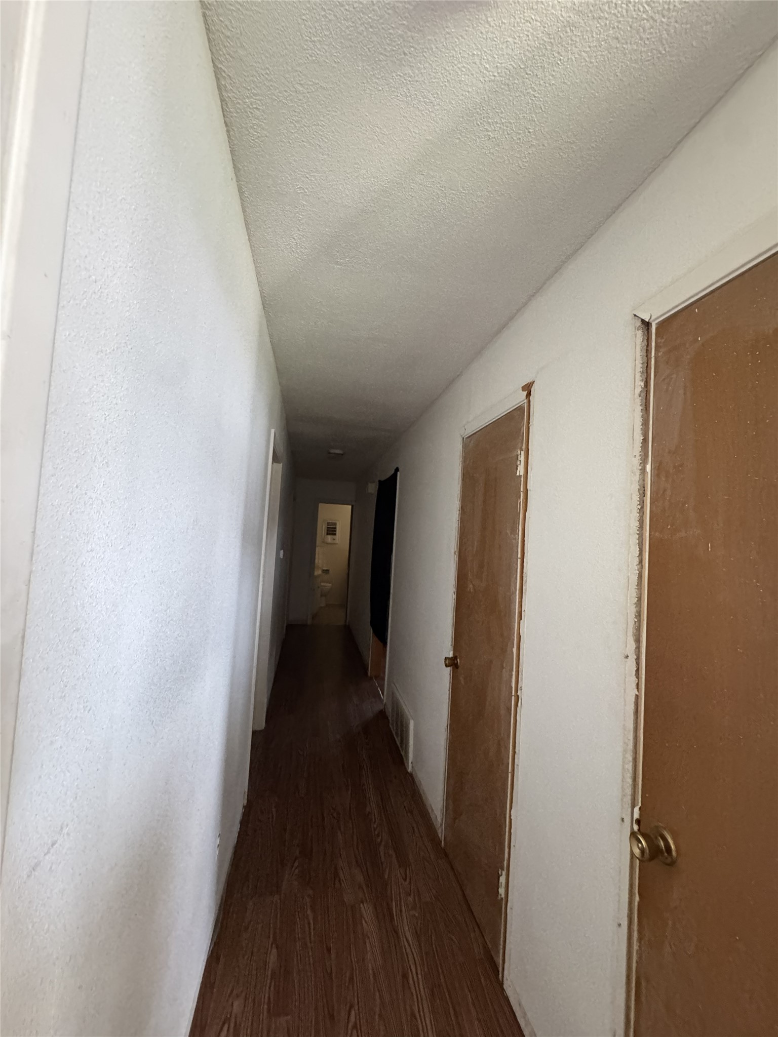 106 North 7th Street Dawson, TX 76639 - Photo 8 of 28 Corridor with dark wood-style flooring and a textured ceiling