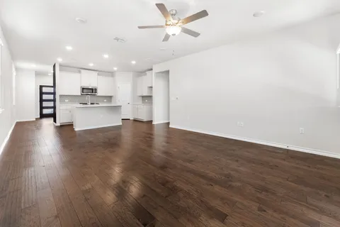 a kitchen with granite countertop white cabinets and black appliances