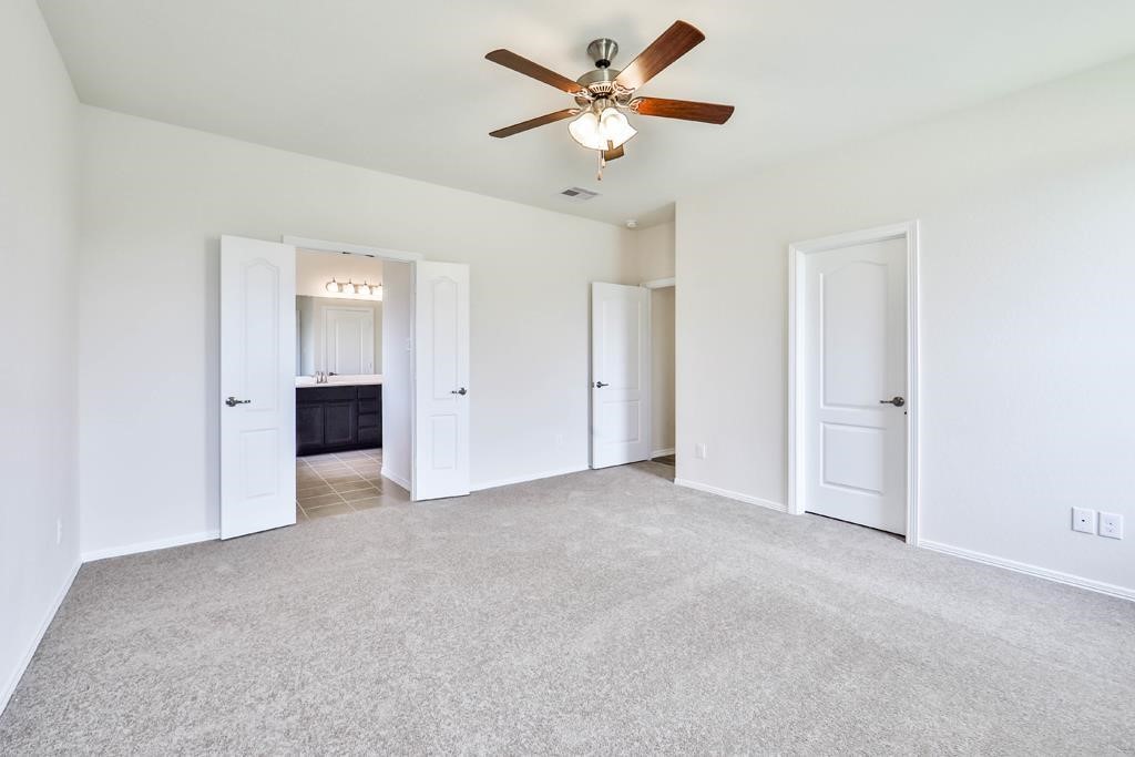 247 Sintra Lk Way Rosenberg, TX 77469 - Photo 15 of 28 a view of an empty room with a ceiling fan