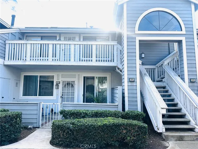 a view of a house with more windows and a small yard