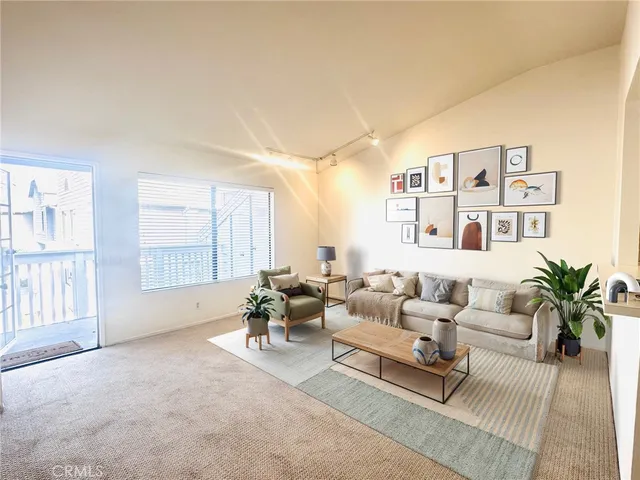 a living room with furniture and large windows