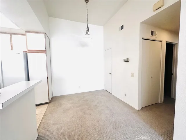 a view of empty room with wooden floor and window