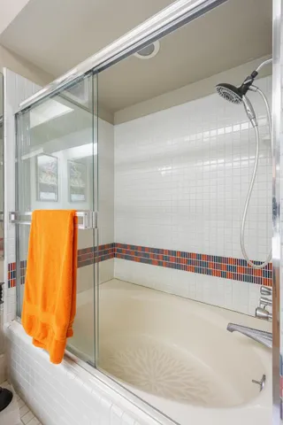 a bathroom with a shower and a glass door
