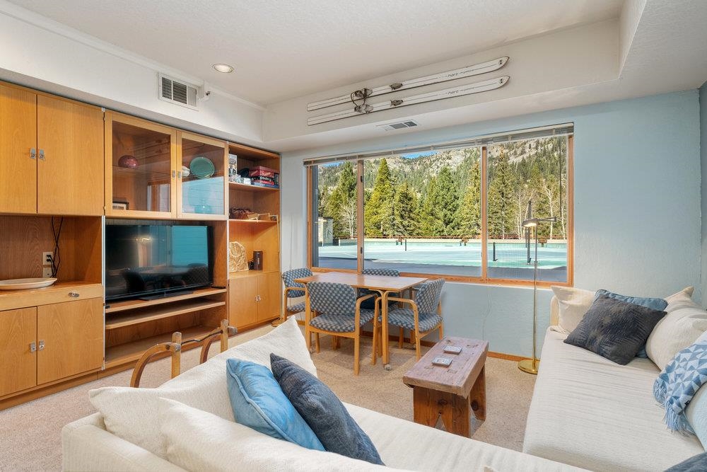 201 Shirley Cyn Road, Unit 233 Olympic Valley, CA 96146 - Photo 2 of 27 a living room with furniture and a flat screen tv
