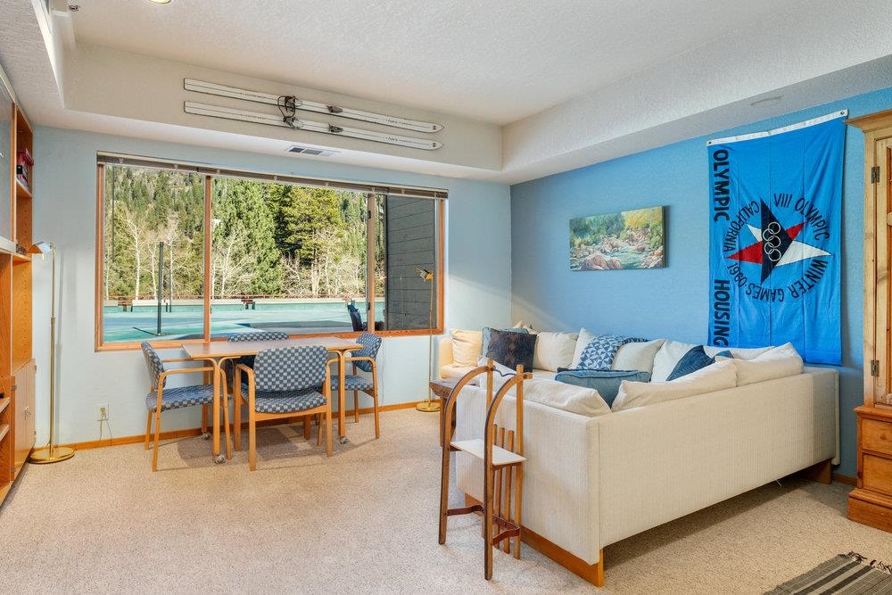 201 Shirley Cyn Road, Unit 233 Olympic Valley, CA 96146 - Photo 3 of 27 a living room with furniture and a large window
