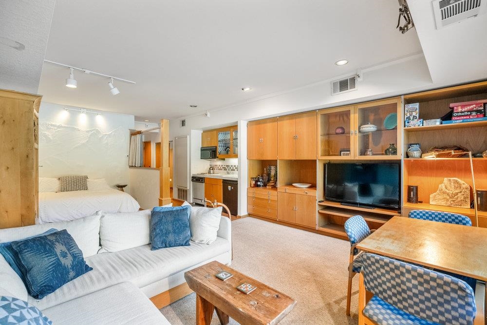 201 Shirley Cyn Road, Unit 233 Olympic Valley, CA 96146 - Photo 6 of 27 a living room with furniture and a flat screen tv