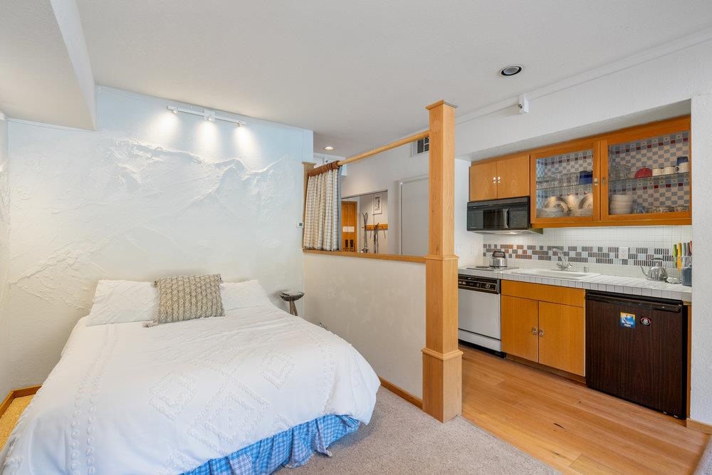 201 Shirley Cyn Road, Unit 233 Olympic Valley, CA 96146 - Photo 7 of 27 a bedroom with a bed and wooden floor