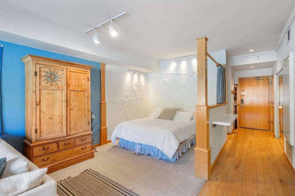 201 Shirley Cyn Road, Unit 233 Olympic Valley, CA 96146 - Photo 10 of 27 a bedroom with a bed and wooden floor