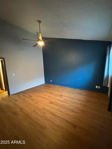 a view of empty room with fan and window