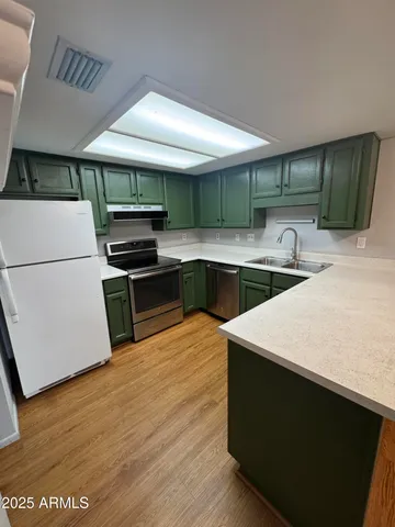 a kitchen with a stove and a refrigerator