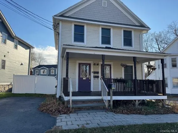 a view of a house with a yard and wooden floor
