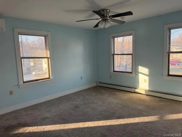 a view of an empty room window and wooden floor