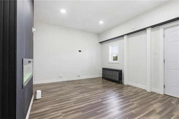 a view of a room with wooden floor and windows