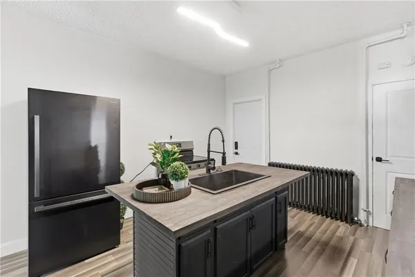 a kitchen with a sink appliances and cabinets