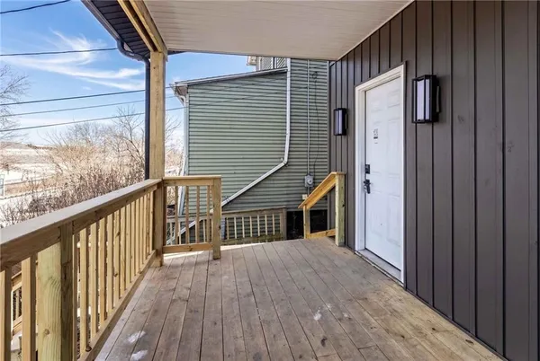 a view of a house with a door and wooden floor