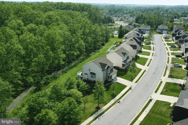 an aerial view of a house with a yard and lake view
