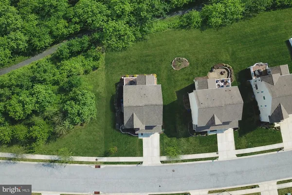 an aerial view of a house with a garden and trees