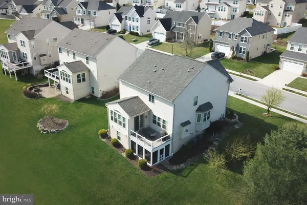 an aerial view of a house with backyard