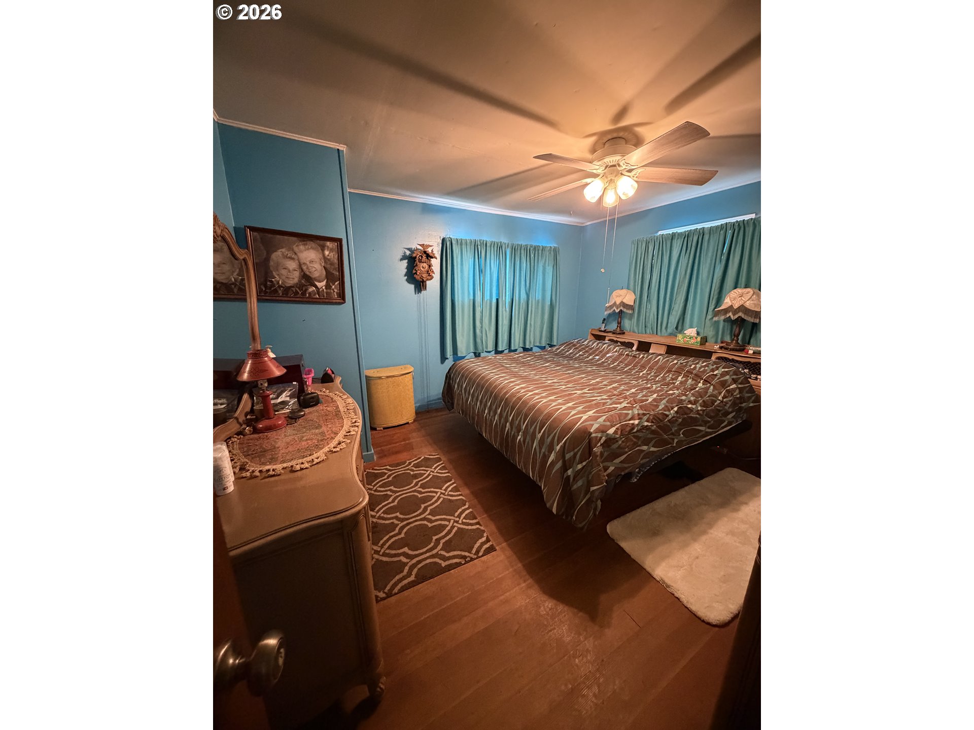 1009 Fir Avenue Reedsport, OR 97467 - Photo 7 of 16 a bedroom with a bed and a chandelier