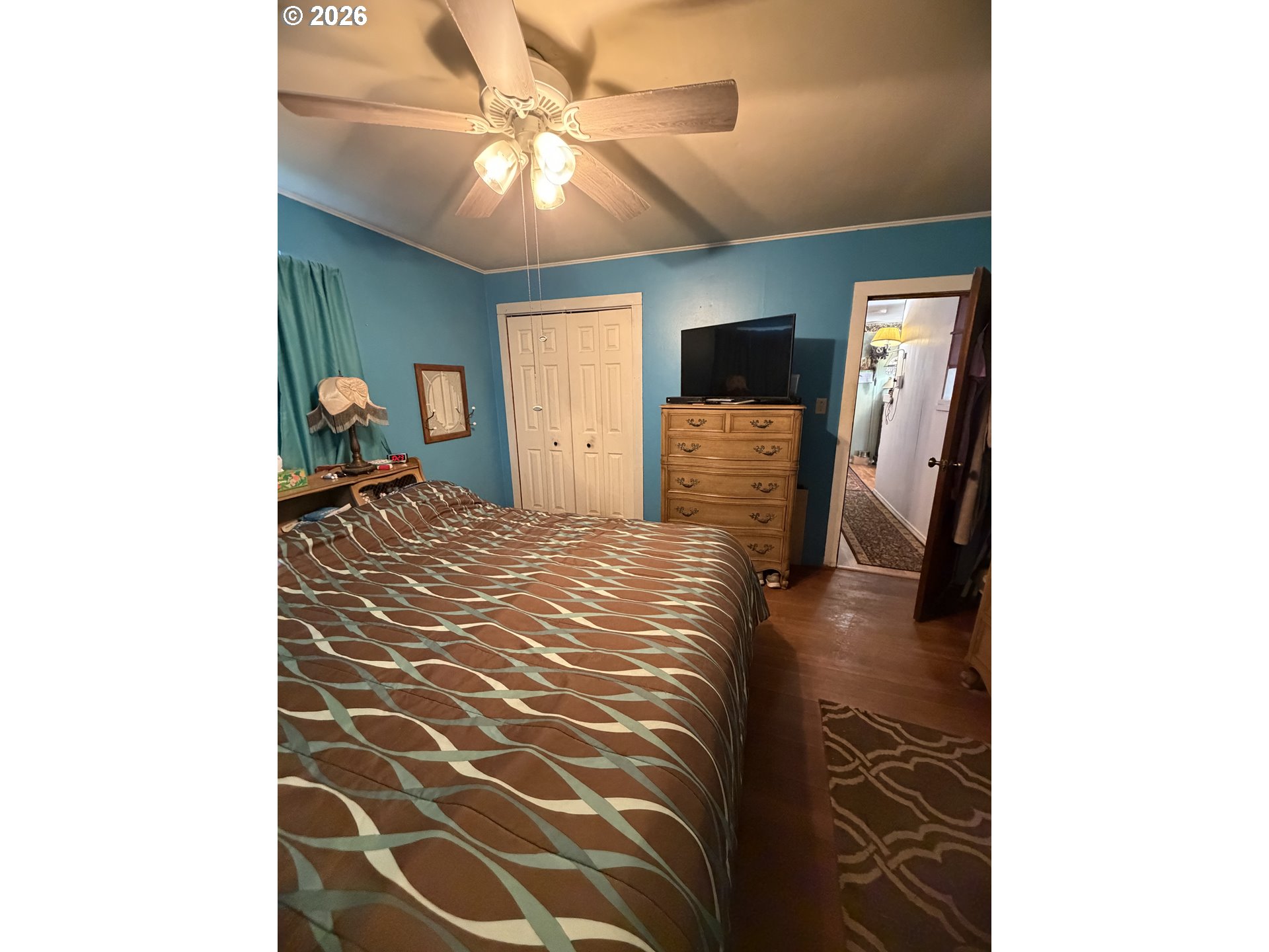 1009 Fir Avenue Reedsport, OR 97467 - Photo 8 of 16 a bedroom with a bed and a chandelier