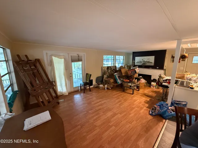a view of a livingroom with furniture and a flat screen tv