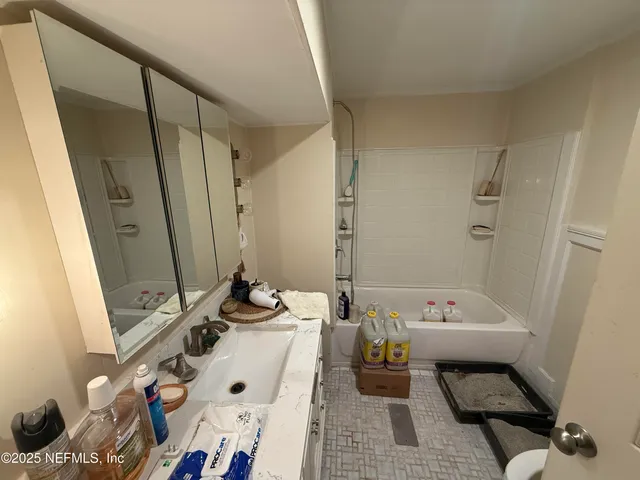 a bath room with a sink and a mirror