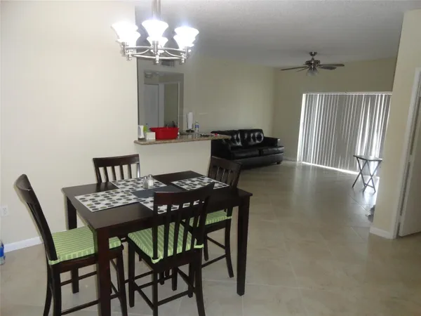 a view of a dining room with furniture and a chandelier