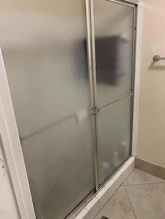 a bathroom with a glass shower door