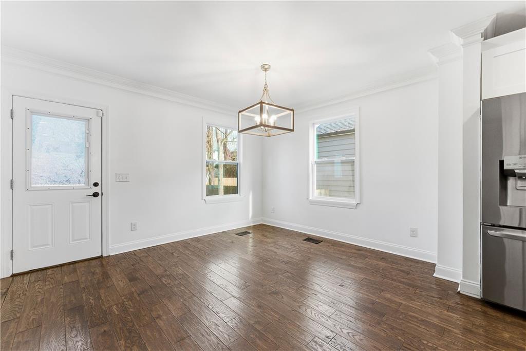 1779 North Olympian Way Southwest Atlanta, GA 30310 - Photo 15 of 48 an empty room with wooden floor cabinet and windows