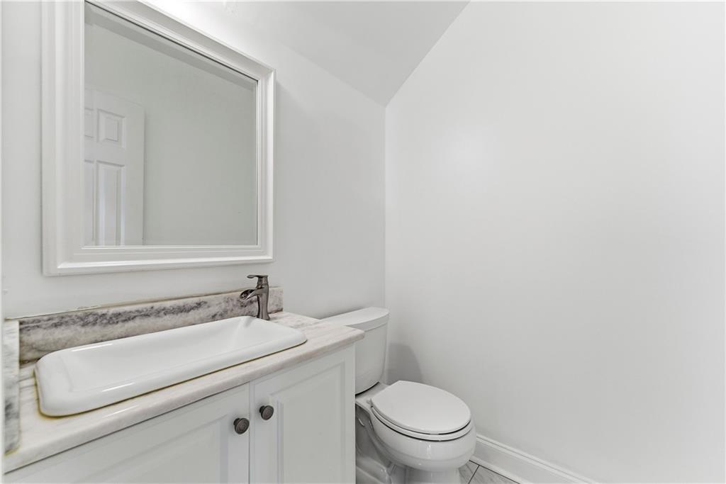 1779 North Olympian Way Southwest Atlanta, GA 30310 - Photo 17 of 48 a bathroom with a granite countertop sink and a mirror