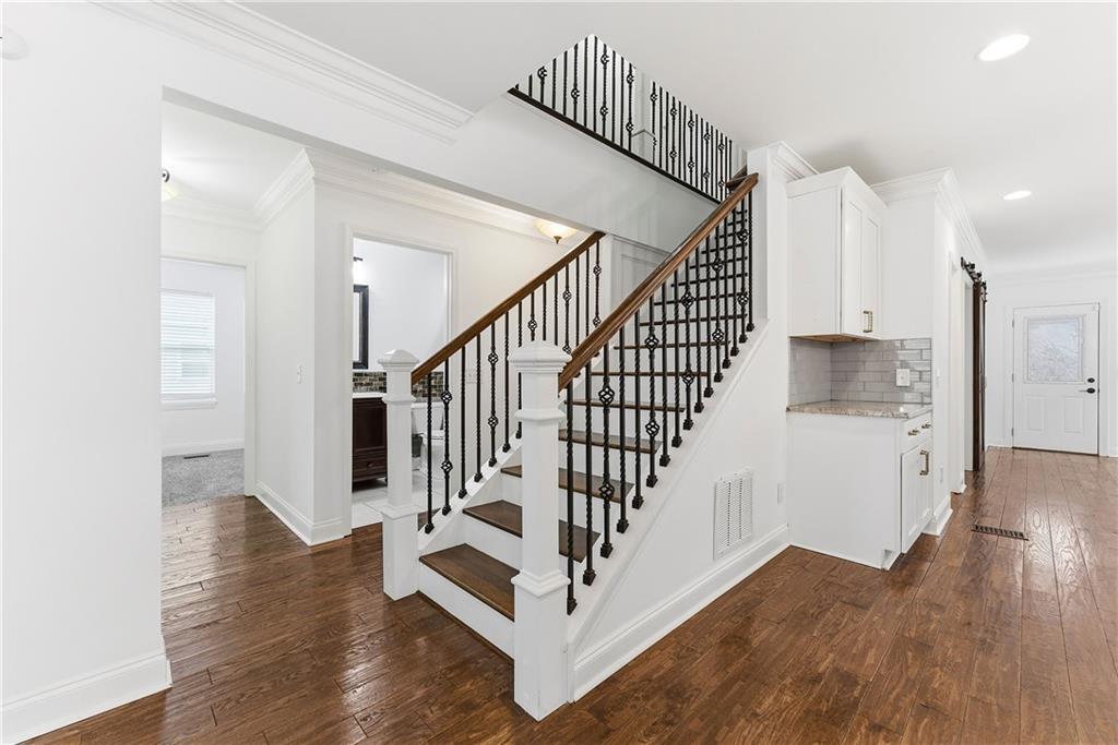 1779 North Olympian Way Southwest Atlanta, GA 30310 - Photo 18 of 48 a view of entryway with wooden floor and stairs