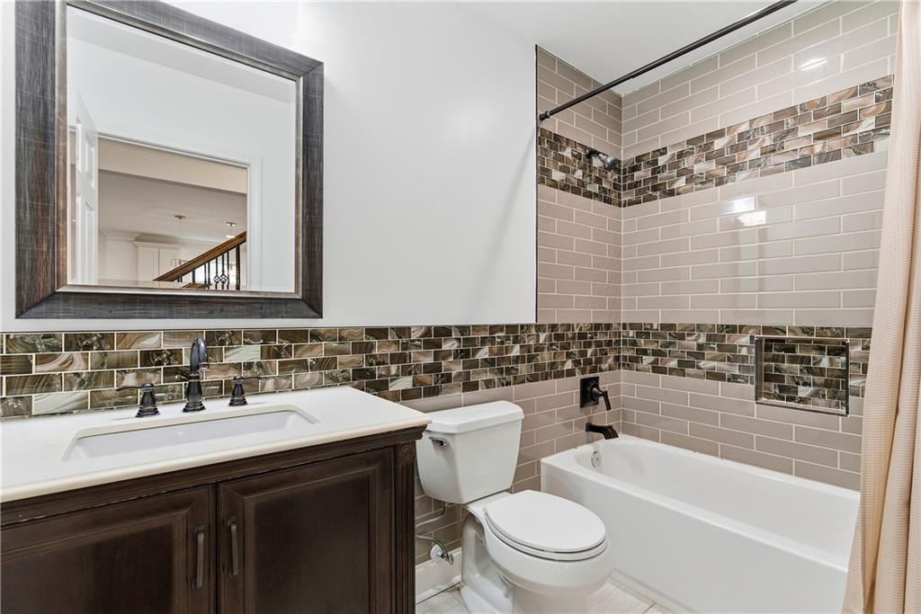 1779 North Olympian Way Southwest Atlanta, GA 30310 - Photo 19 of 48 a bathroom with a sink vanity mirror and toilet