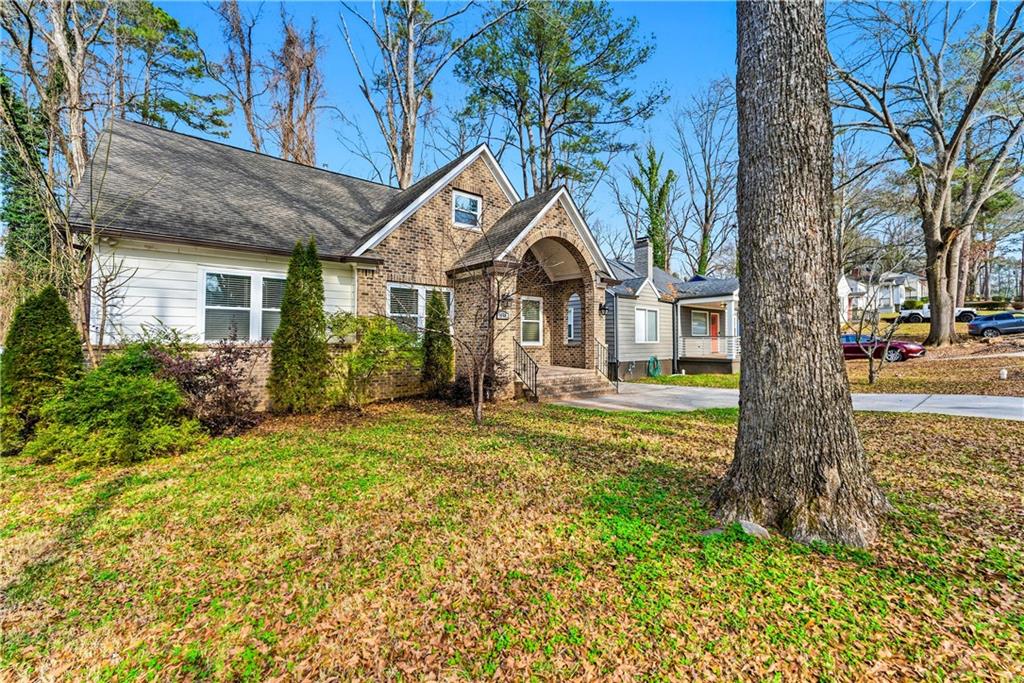 1779 North Olympian Way Southwest Atlanta, GA 30310 - Photo 2 of 48 a front view of a house with garden