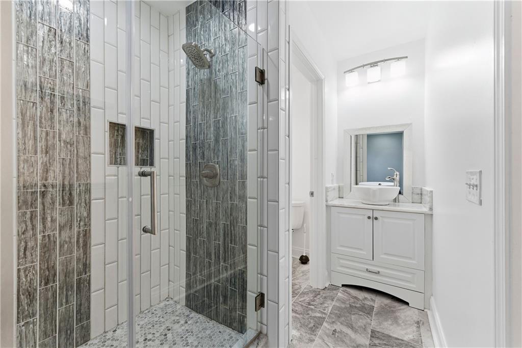 1779 North Olympian Way Southwest Atlanta, GA 30310 - Photo 27 of 48 a bathroom with a shower and a sink