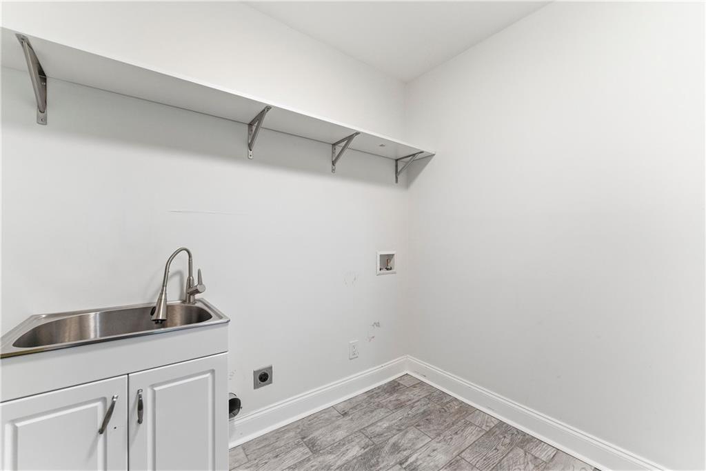 1779 North Olympian Way Southwest Atlanta, GA 30310 - Photo 28 of 48 a bathroom with a sink and vanity
