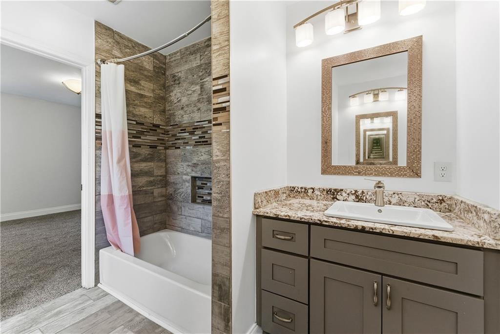 1779 North Olympian Way Southwest Atlanta, GA 30310 - Photo 32 of 48 a bathroom with a tub sink and mirror