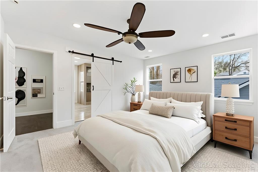 1779 North Olympian Way Southwest Atlanta, GA 30310 - Photo 34 of 48 a bedroom with a large bed and a chandelier